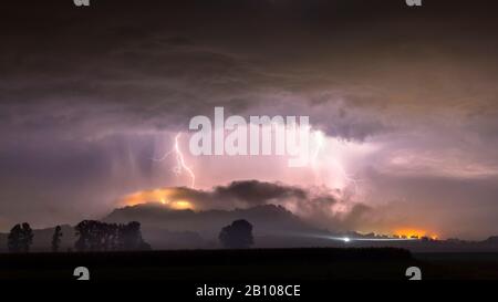 Powerful flashes of earth behind the fog-swallowed mountain of Amöneburg, Hessen, Germany Stock Photo