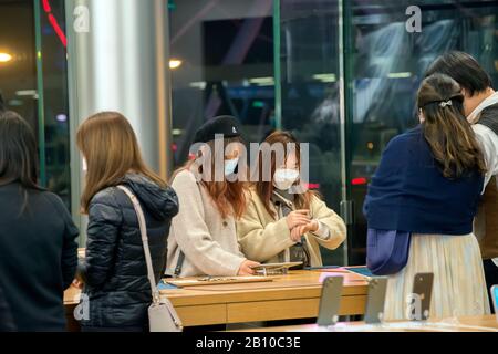 Two Chinese girls in a computer shop buying smartphones, Hong Kong, China. Stock Photo