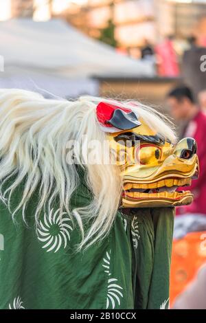 ueno, japan - january 02 2020: Japanese dancer who wears the new year's  traditional Shishimai lion costume composed of a wooden head with eyes gilded Stock Photo
