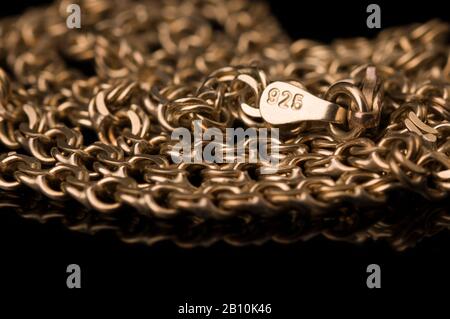 golden necklace of test 925 on a black background. close up Stock Photo