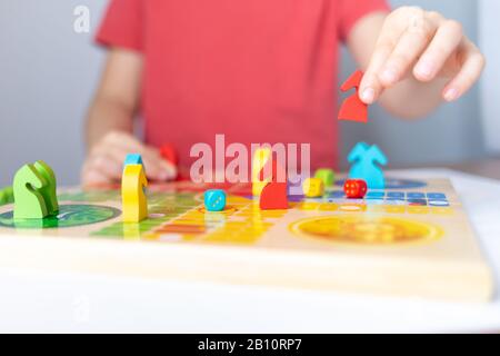 board game concept, colorful figures in kid hand Stock Photo