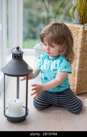 Little girl is playing with lantern Stock Photo