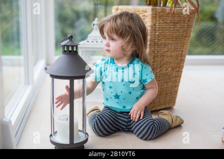 Little girl is playing with lantern Stock Photo