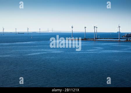 Wind farm in front of Oresund Bridge in Oresund, Copenhagen, Denmark Stock Photo