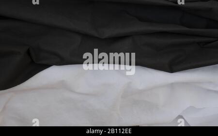 Cloth waves close up the background, Stacked Creased fabric 3 color black white, elegant wallpaper design, wavy folds of grunge silk texture satin vel Stock Photo