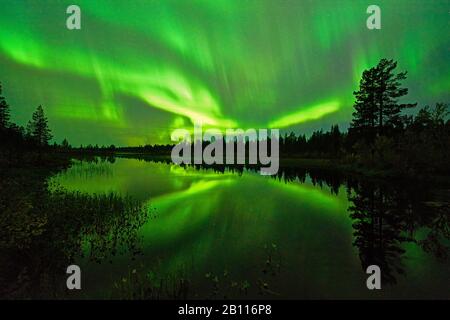polar light mirroring on a lake, Sweden, Lapland, Norrbotten Stock Photo