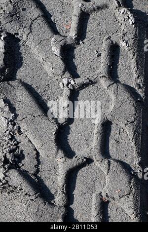 Tire imprints on the sandy road in black and white Stock Photo