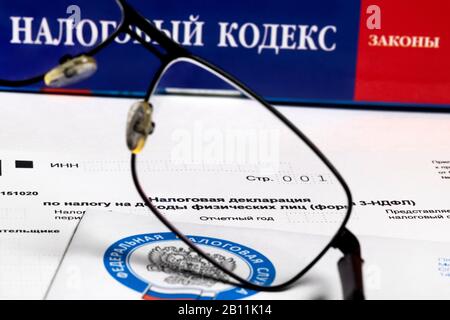 View of the Individual Income Tax declaration (3-NDFL form) against the background of the Tax Code of the Russian Federation Stock Photo