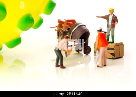 closeup of big corona virus with a team of miniature figurines of workers preparing for taking action against very dangerous deadly virus type on whit Stock Photo