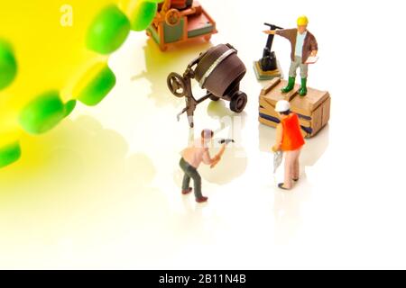 closeup of big corona virus with a team of miniature figurines of workers preparing for taking action against very dangerous deadly virus type on whit Stock Photo