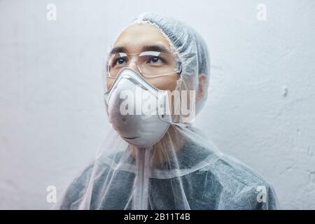 Asian young man in protective mask and glasses looking up isolated on white background Stock Photo