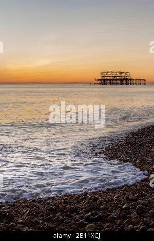 wave breaking on Brighton seafront at dusk Stock Photo