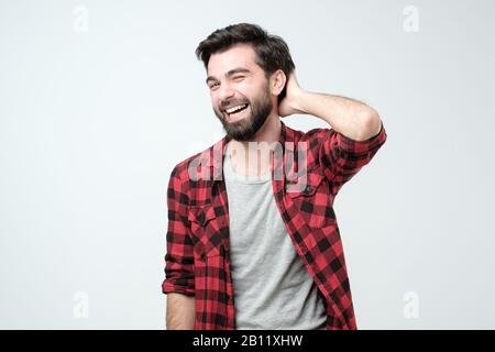 Happy casual hispanic man laughing on joke. Positive facial human emotion. Stock Photo