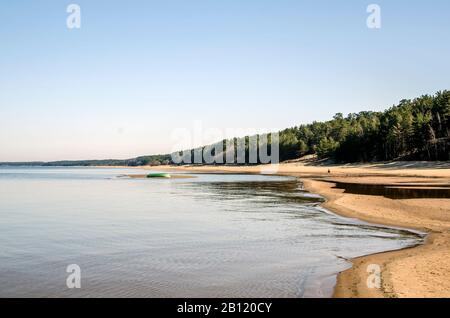 The White Dune and Baltic see at Saulkrasti in spring, Latvia. White sand beach near conifer trees forest in Baltic. Stock Photo