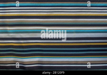 Floor carpet with stripes texture background. White, yellow, blue, black, gray striped rug Stock Photo