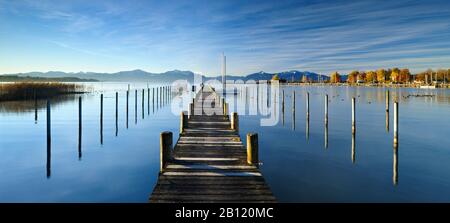 Autumn morning on Lake Chiemsee, landing stage and Chiemgau Alps, Seebruck, Bavaria, Germany Stock Photo