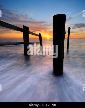 Sunset on the west beach, fence and posts, Darß, Baltic Sea, Vorpommersche Boddenlandschaft National Park, Mecklenburg-West Pomerania, Germany Stock Photo