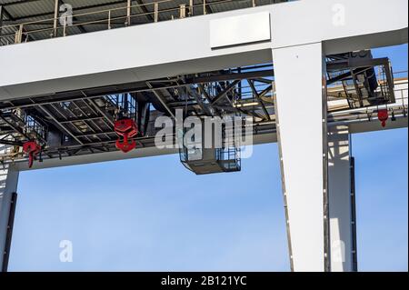 glassy operator cabin under the bridge of a gantry crane with trolley Stock Photo