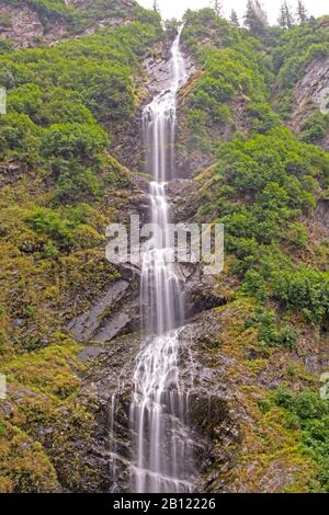 Dramatic Bridal Veil Falls in the Mist of Keystone Canyon near Valdez, Alaska Stock Photo