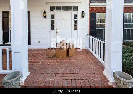 Shipping boxes on front porch of home Stock Photo