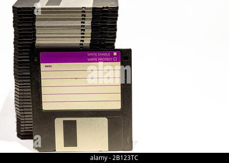 numerous black floppydisks lined up on a white background Stock Photo