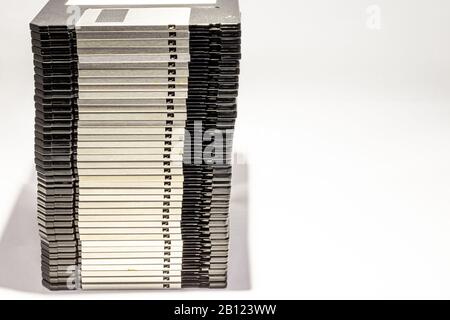 numerous black floppydisks lined up on a white background Stock Photo