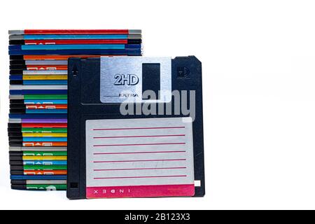 numerous black floppydisks lined up on a white background Stock Photo