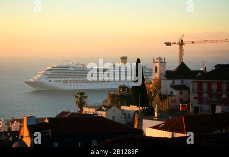 Cruise ships pass Miradouro de Santa Luzia above the Tejo River, when they are leaving or arriving. There is also a cruise port down by the river. Stock Photo