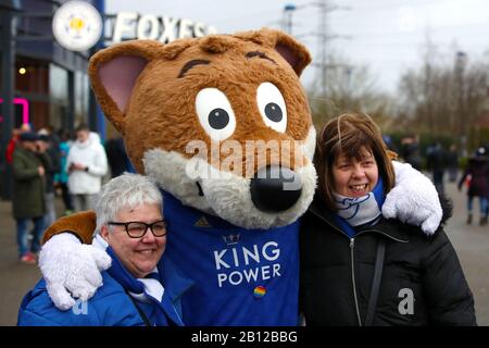 Fans pose with Leicester City mascot Filbert Fox ahead of the Premier League match at the King Power Stadium, Leicester. Stock Photo