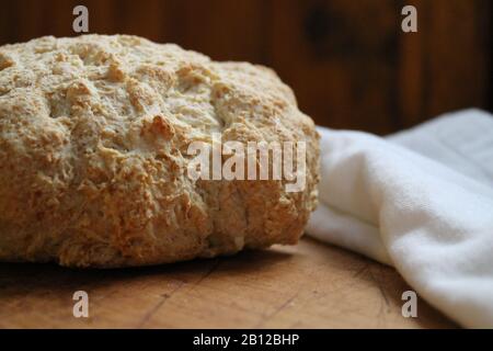 Fresh baked bread on wooden countertop Stock Photo