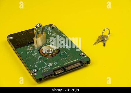 hard drive on a yellow background with a lock and keys d Stock Photo
