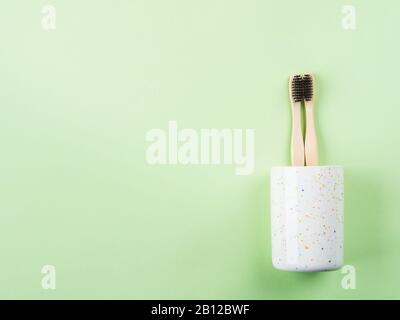 Bamboo toothbrushes for two in ceramic glass Stock Photo