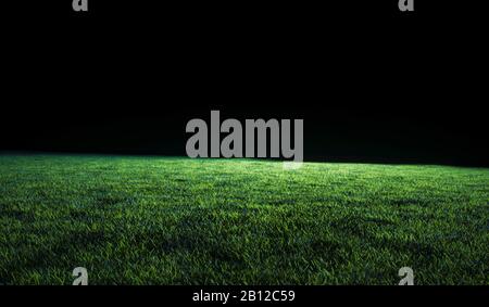 Low angle view across the neatly cut green grass of a lawn or sports field in shadowy evening light for use as a background image Stock Photo
