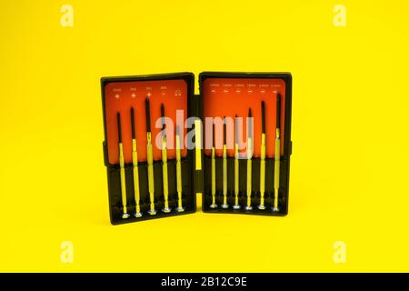 set of screwdrivers on a yellow background isolated d Stock Photo