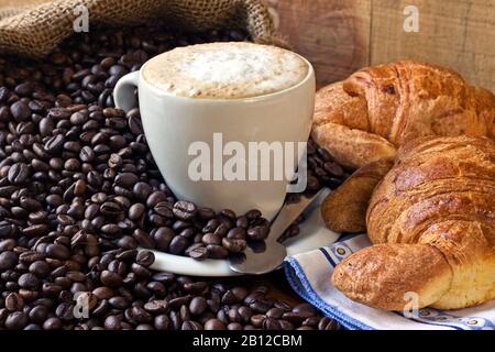 cappuccino, brioches and newspaper with background Stock Photo