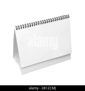 Blank real paper desk spiral calendar isolated on white background, front diagonal view Stock Photo
