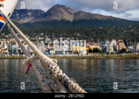 Shallow focus on the mooring lines from a cruise ship to the dock at a travel destination. Stock Photo