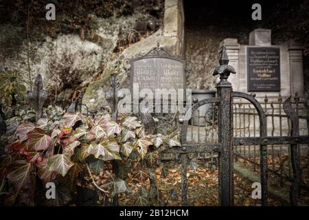 Tombstone and graves in an ancient church graveyard Stock Photo