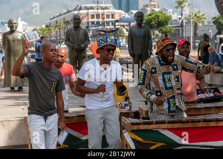 Cape Town, South Africa. December 2019. Street musician in colourful clothing plays xylophone on the waterfront area of central Cape Town. Stock Photo