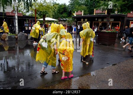 Children and adults in the amusement park Legoland in Billund, Denmark. The picture: A family with raincoats in rainy weather.  Photo Jeppe Gustafsson Stock Photo