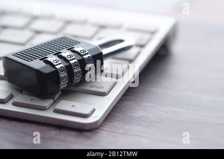 close up of padlock and keyboard on table Stock Photo