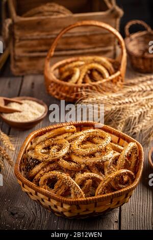 Pretzel rings in rustic basket on wooden board Stock Photo