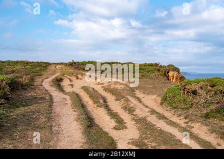 A rutted, well used South West Coast Path leading from Western Hill, south of Portreath, over the Caravannel Downs - Portreath, north Cornwall, UK. Stock Photo