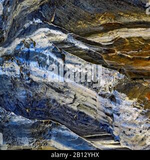 Abstract colour photograph of coastal rock the image is a colour abstract with a near impressionism style, containing rock patterns and textures in bl Stock Photo