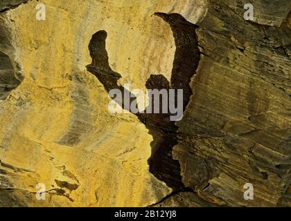 Abstract colour photograph of coastal rock the image is a colour abstract with a near impressionism style, containing rock patterns and textures. Stock Photo