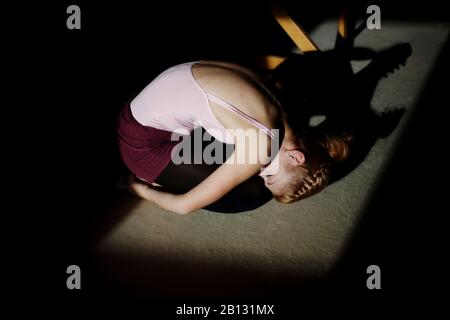 Young woman kneeling on the floor,portrait Stock Photo