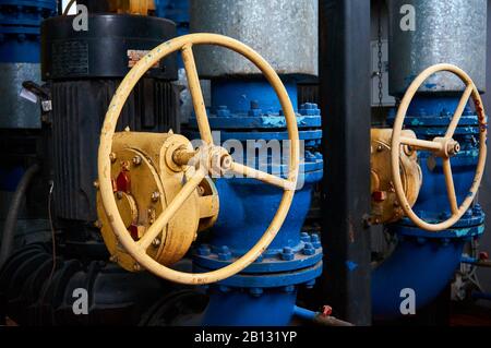 Valve with yellow helm on the pipeline. Stock Photo