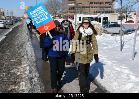 Ottawa, Canada - February 21, 2020: A group of Ontario teachers carry pickets on Merivale Rd during their province wide one day strike in protest of the cuts being made by Premier Doug Ford.  It was the first time since 1997 that all four major unions walked out on strike. Stock Photo