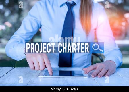 Writing note showing Project Charter. Business concept for typically short formal document that describes your project Female business person sitting Stock Photo