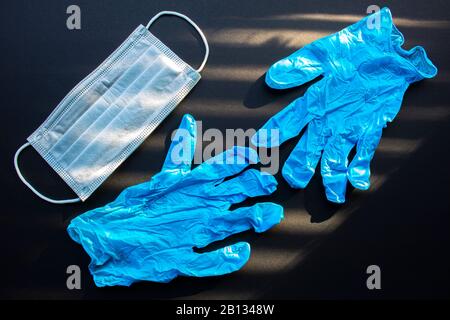 Surgical Masks, Face Mask Disposable and medical gloves on a black background Stock Photo